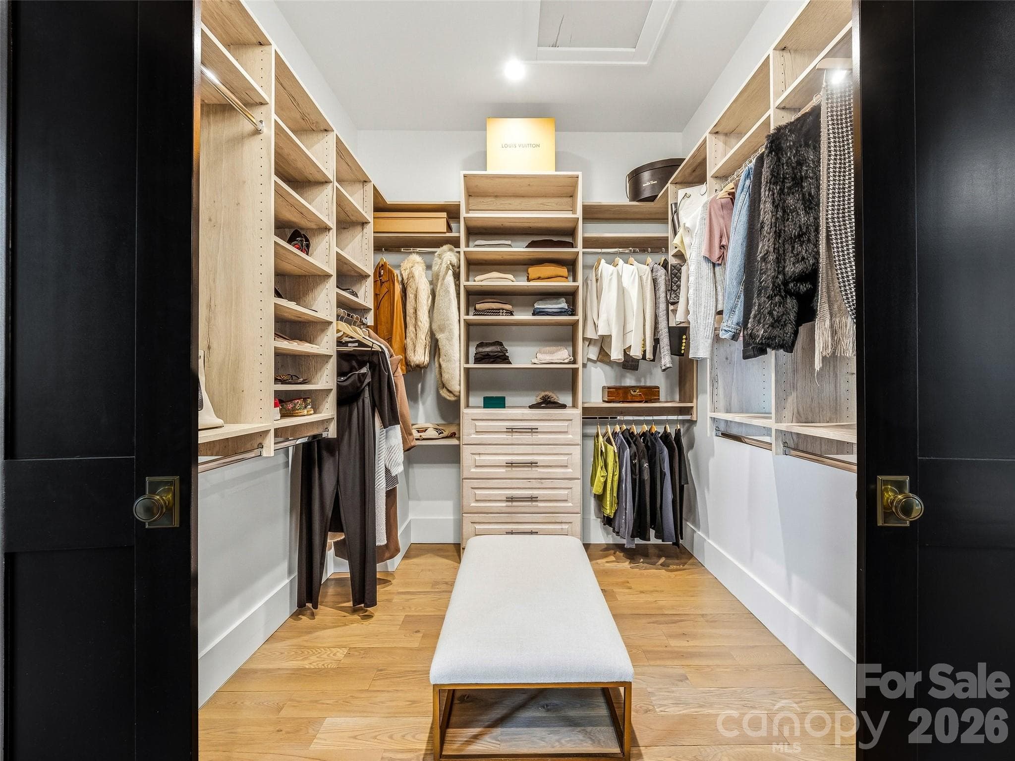 Custom walk-in closet with built-ins and center island for added storage - 241 Tower Circle, Hendersonville