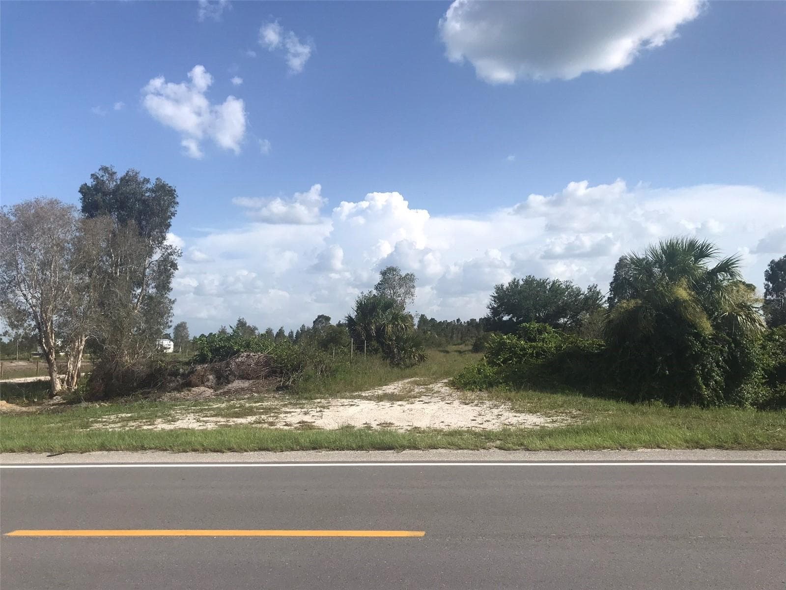 Entrance to 48033 Bermont Rd across 48091 Bemont Road owned by same owner. - 48033 BERMONT RD, PUNTA GORDA
