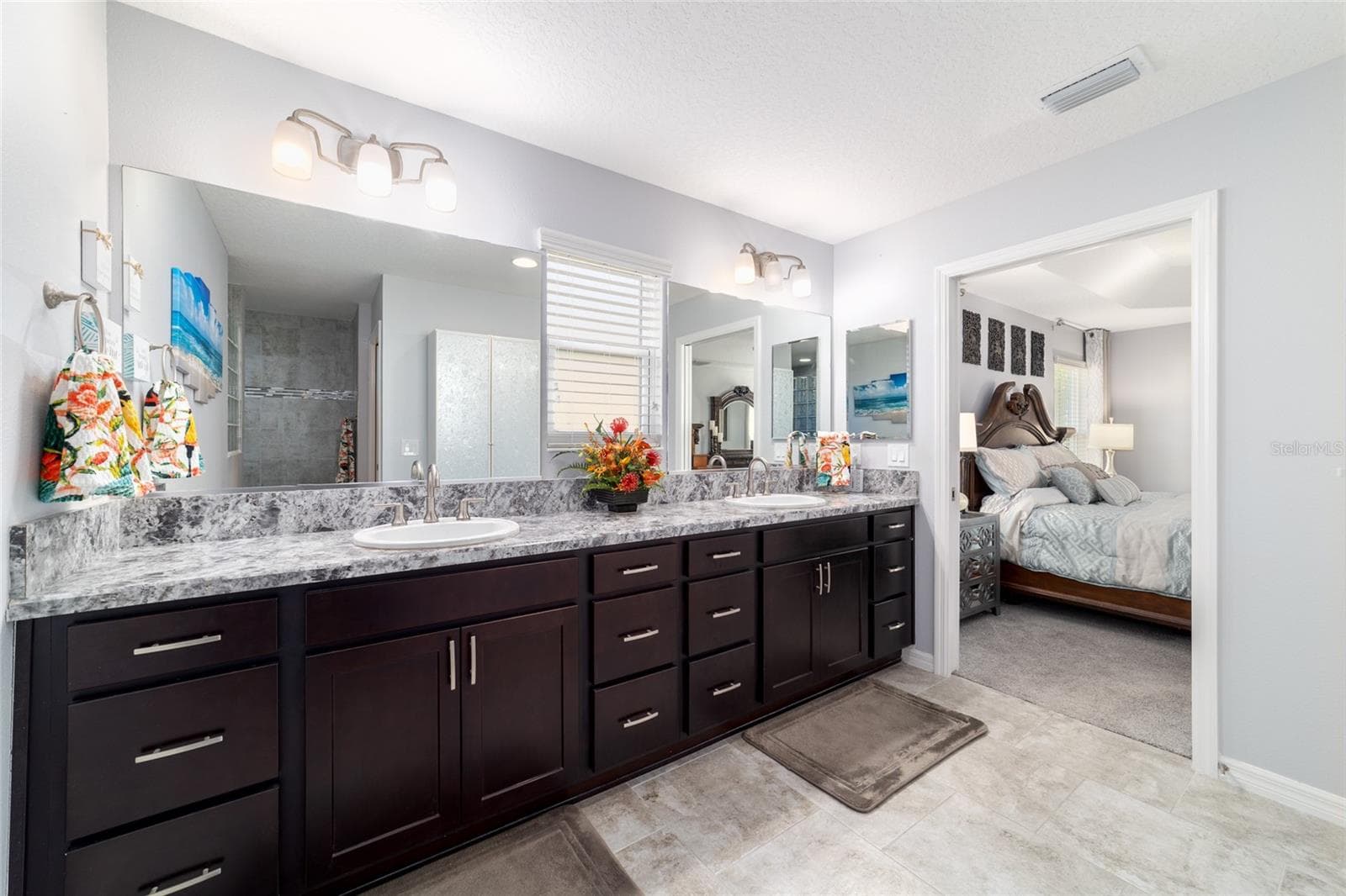 Dual vanities in the primary bath with a private water closet - 1194 MCDONOUGH PL, THE VILLAGES