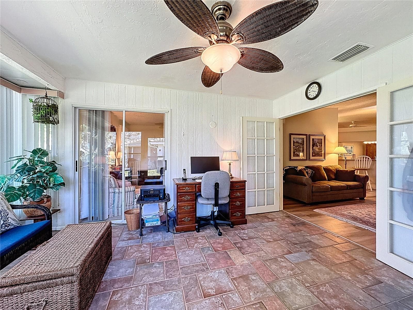 View of the air conditioned Florida room with sliding doors to the primary suite and French doors to the family room. - 5611 GARDEN LAKES DR, BRADENTON