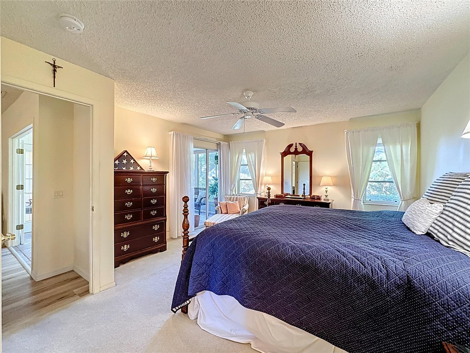 Primary Ensuite bedroom with sliding door leading into the Florida room. - 5611 GARDEN LAKES DR, BRADENTON