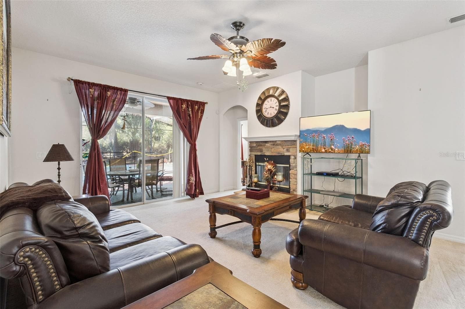 Main living area opening directly to the screened pool and backyard - 30337 GIDRAN TER, MOUNT DORA