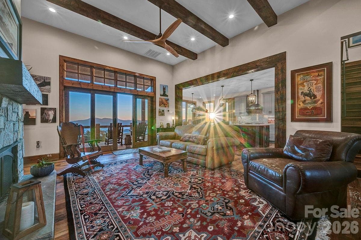 Great room with gas stone fireplace, wood beams - 217 Sunrise Vista Lane, Banner Elk