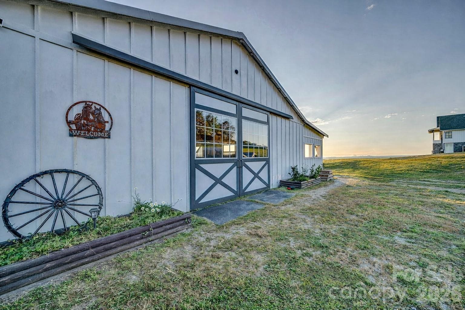 Glass and hardboard sliding end doors, keeping the barn bright - 217 Sunrise Vista Lane, Banner Elk