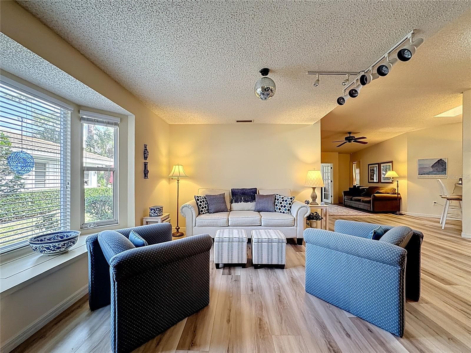 Living room with breakfast bar in the background. - 5611 GARDEN LAKES DR, BRADENTON