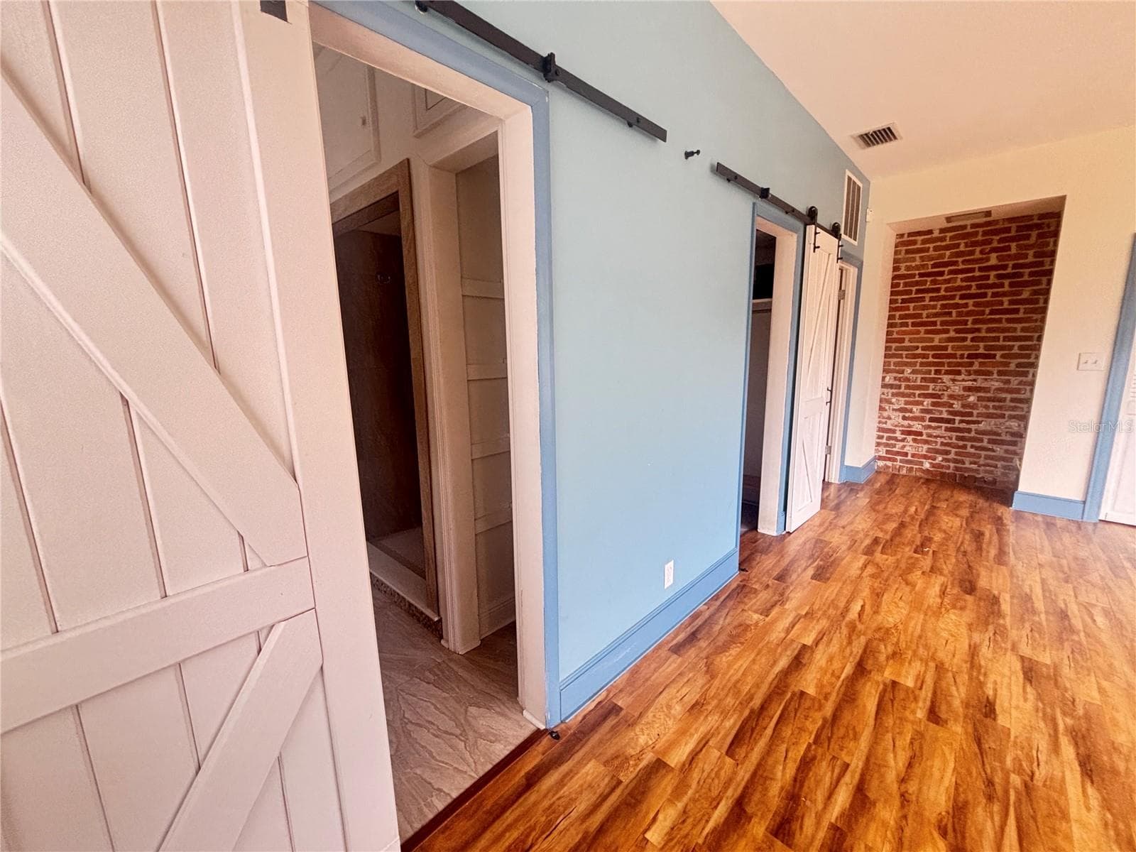 The primary ensuite offers a spacious layout with beautiful wood flooring, abundant natural light, and charming architectural elements - 1508 N ARCADIA AVE, ARCADIA