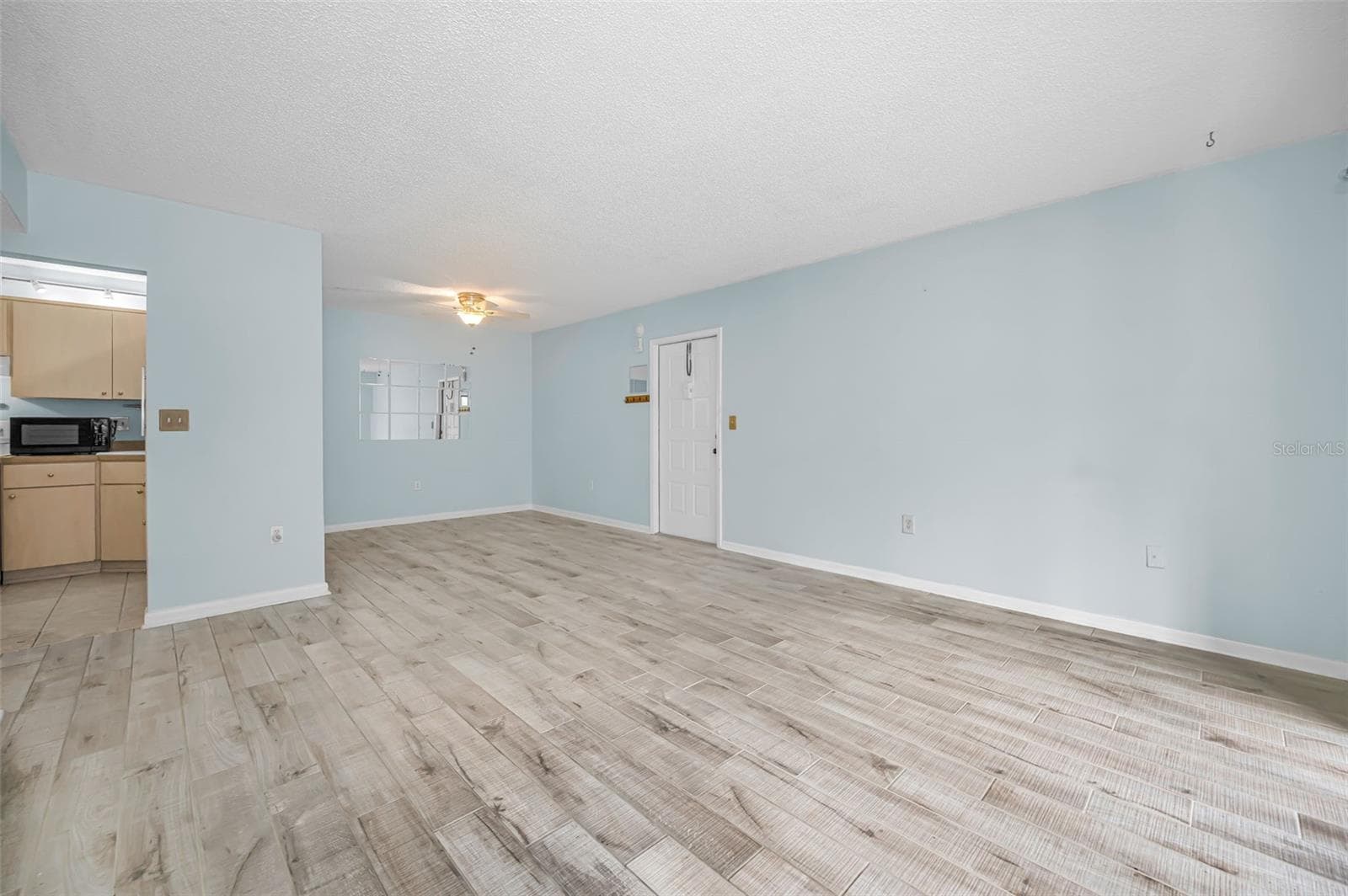 View from living room to dining room and front door - 3232 LAKE PINE WAY E #C1, TARPON SPRINGS