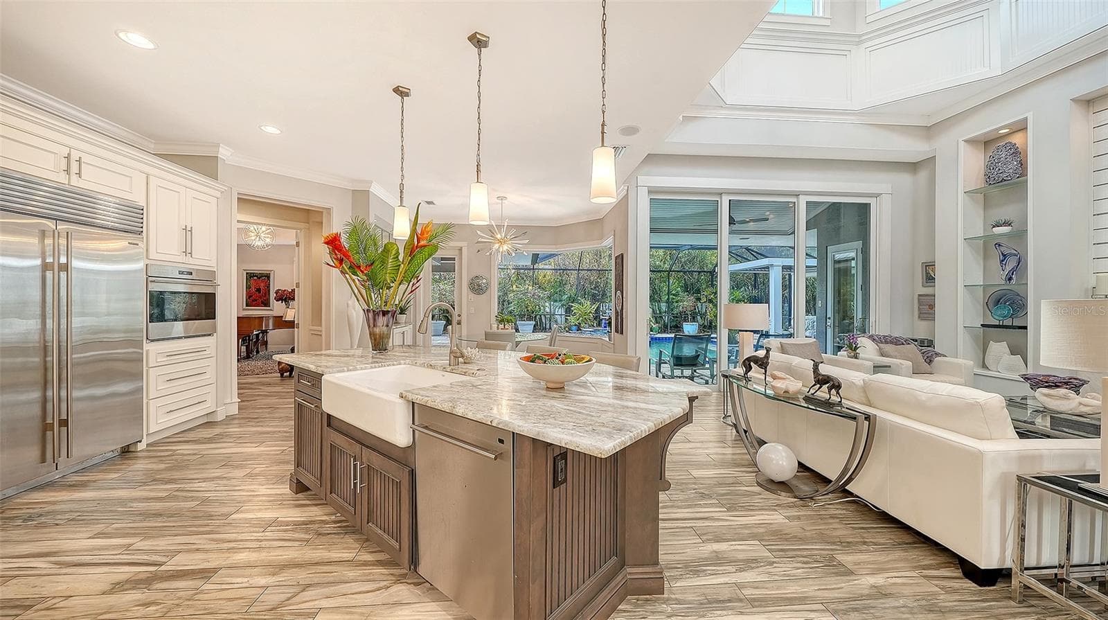 The photo shows the open concept floorplan with a peekaboo view into the bonus room to the left - 1794 CUNLIFF LN, SARASOTA