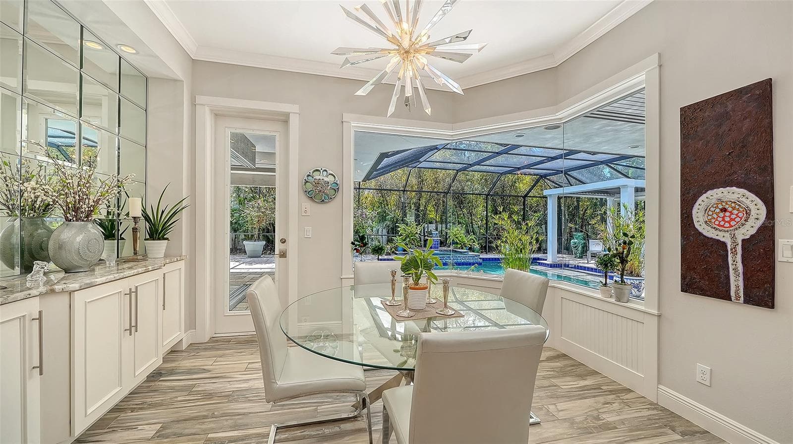 Aquarium glass windows, a custom built-in buffet, and dramatic lighting showcase the dining room - 1794 CUNLIFF LN, SARASOTA