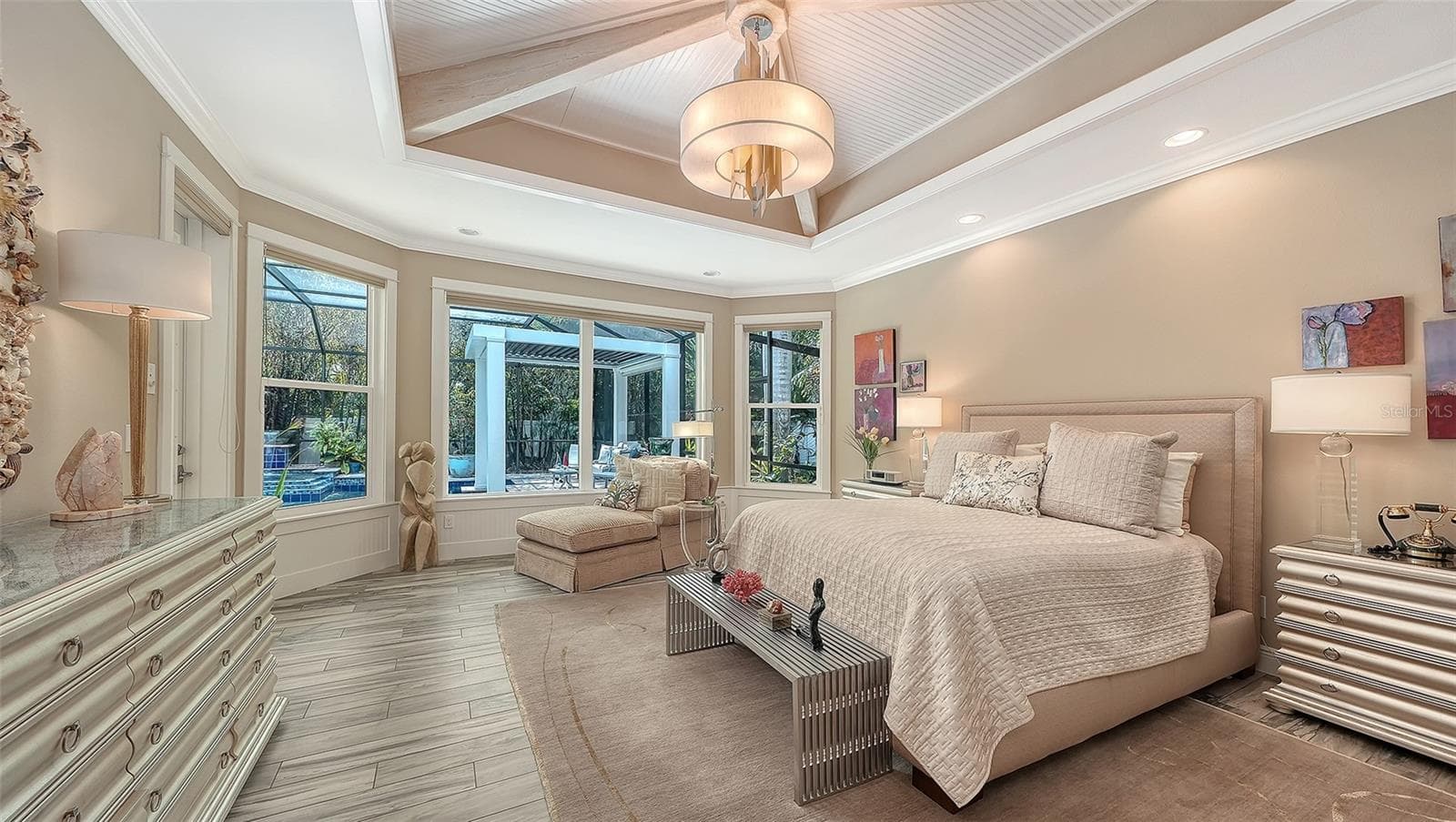 A beautiful chandelier and seating area are just two reasons to fall in love with the primary suite - 1794 CUNLIFF LN, SARASOTA
