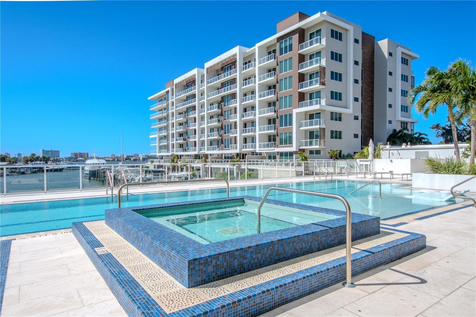 The resort-style amenities at Marina Bay 880 include a stunning 25-meter heated saltwater lap pool designed for both relaxation and fitness. Overlooking the Intracoastal Waterway, the pool features two expansive Baja shelves ideal for lounging in the water’s edge and soaking up the Florida sunshine. A raised spa with mosaic tile detailing provides the perfect spot to unwind while enjoying panoramic water and marina views. Surrounded by sleek glass railings and spacious deck seating, this waterfront oasis blends modern luxury with serene coastal living. - 920 N OSCEOLA AVE #703, CLEARWATER