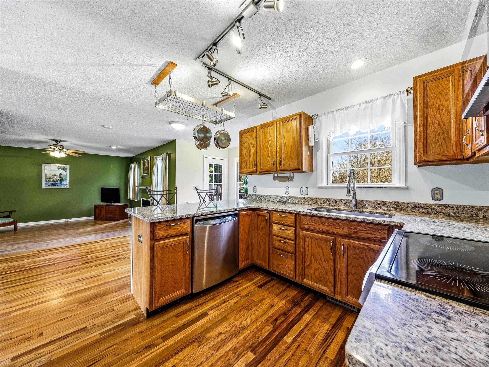 Kitchen opens up to family room and back deck. - 61 Rolling Hills Road, Mills River
