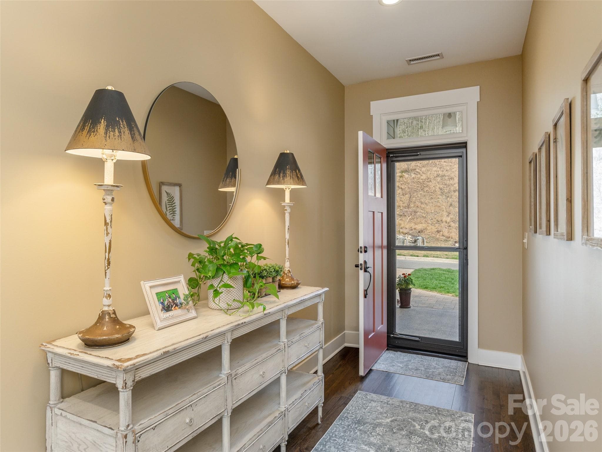 Elevated entry foyer featuring rich, warm hardwood flooring and neutral paint tones, creating a welcoming and timeless first impression. - Hendersonville
