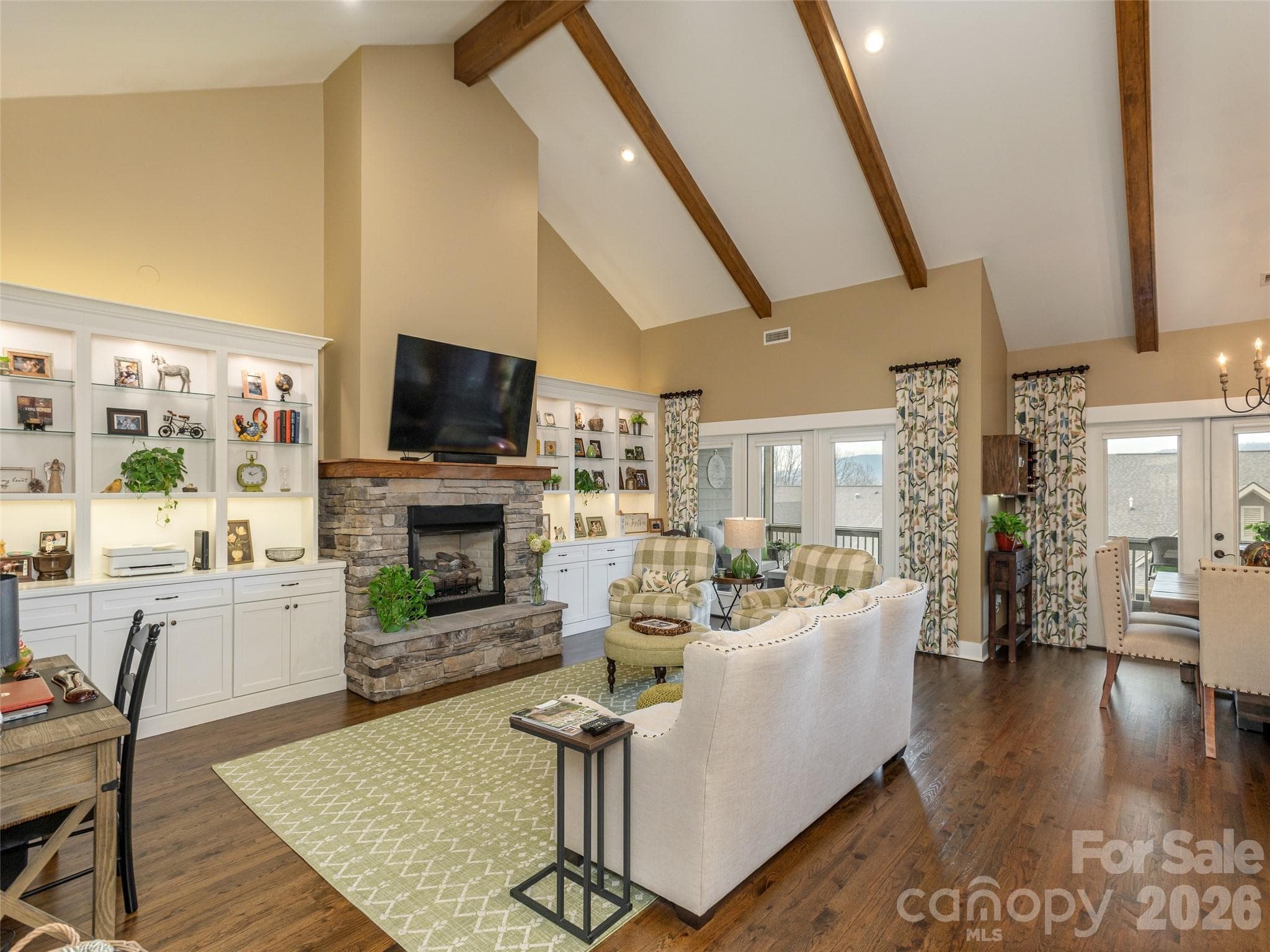 Exposed wood beams accentuate the soaring ceilings, adding warmth, character, and architectural interest to the space. - Hendersonville