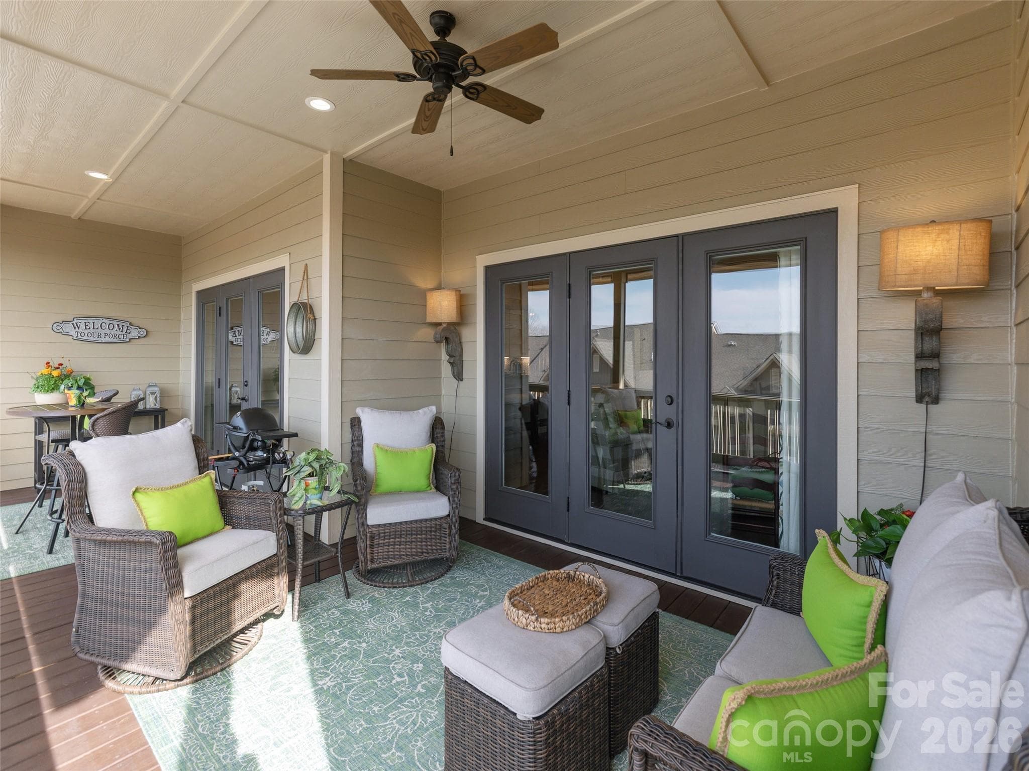 The screened back porch is effortlessly accessed through French doors off the living room, creating a seamless transition between indoor and outdoor living. - Hendersonville