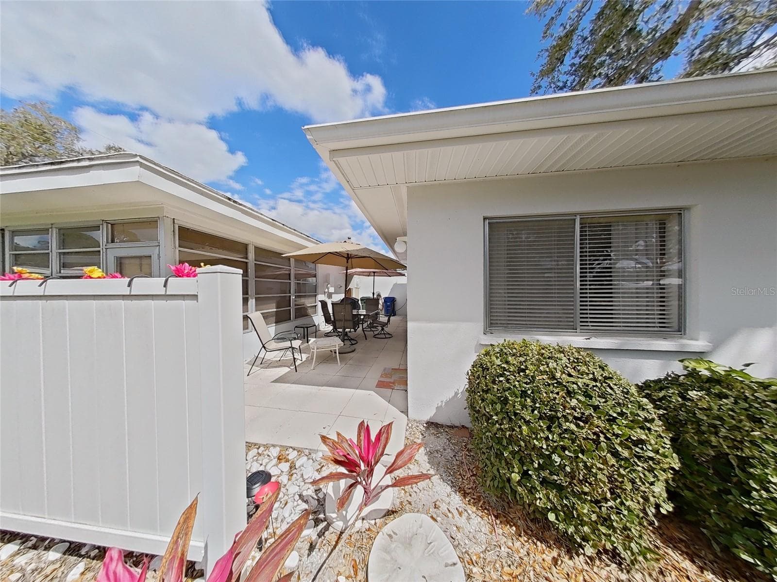 The back yard leads into the shared patio space. - 1845 VERA PL #29, SARASOTA