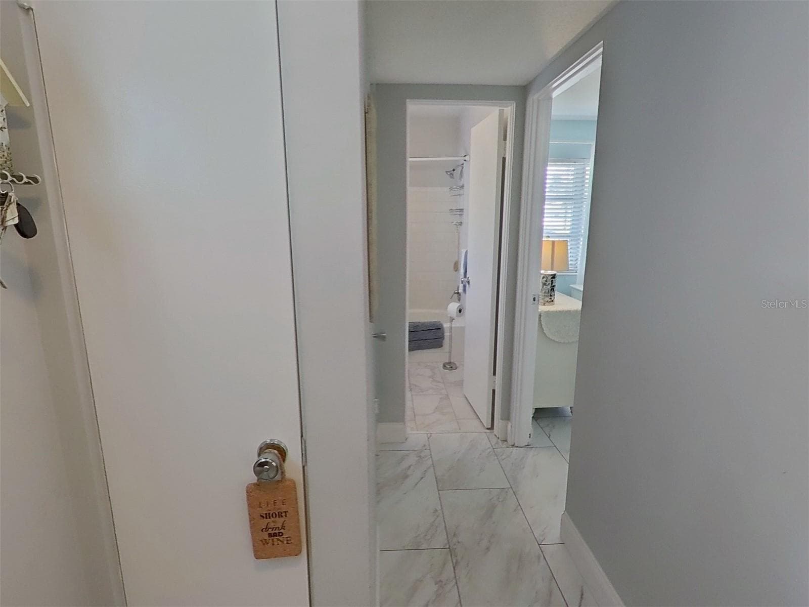 Tiled Hallway leading into the guest bedroom and bathroom - 1845 VERA PL #29, SARASOTA