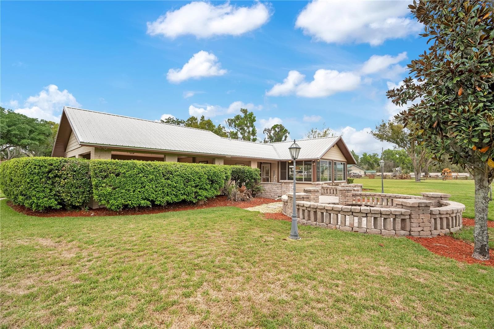 Back of house with patio/firepit - 1401 BUELL CT, PLANT CITY
