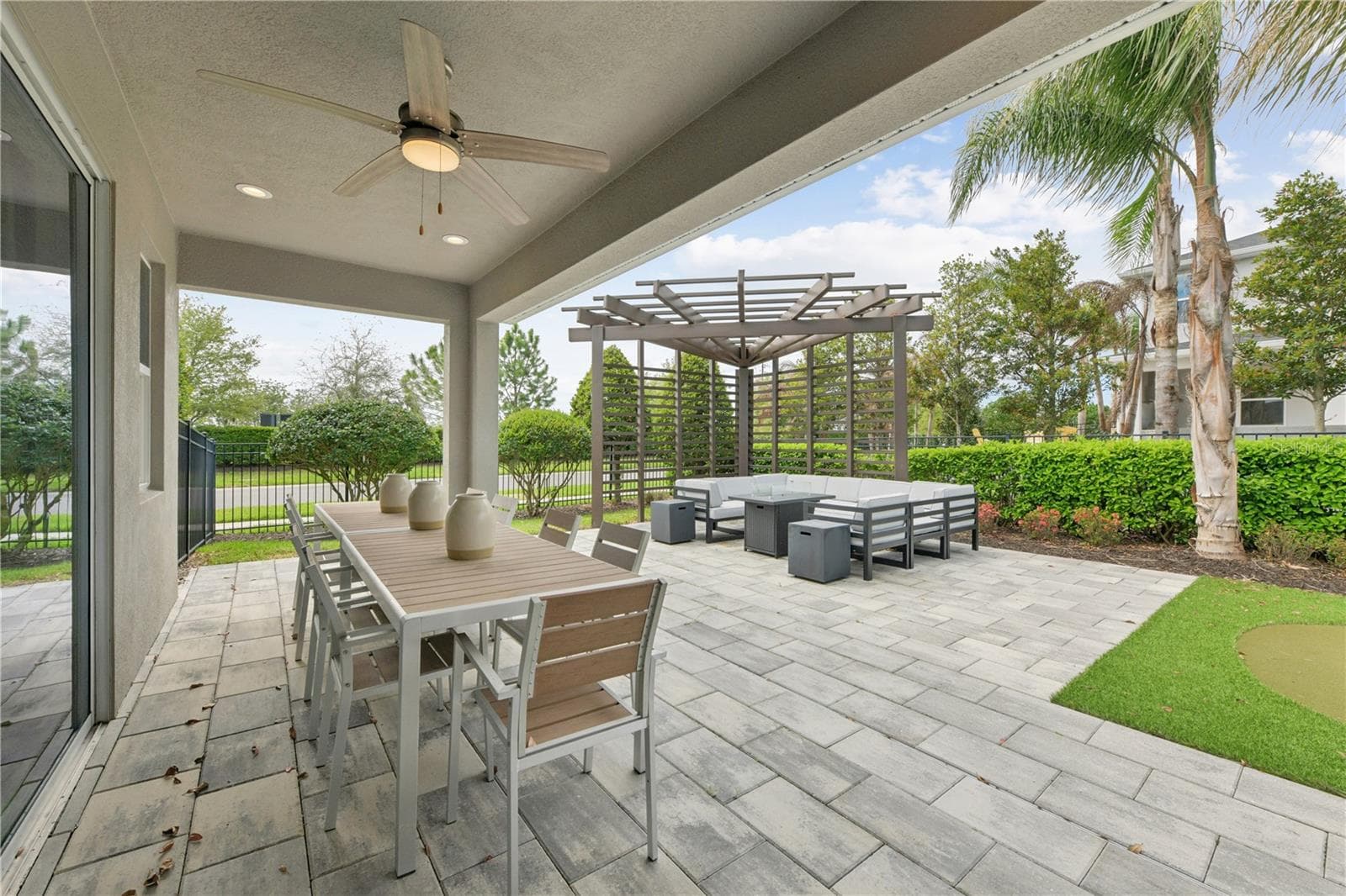 Relaxed outdoor living with an upgraded lanai, lush putting green, and stylish furnished gazebo. - 2418 PARK RIDGE ST, APOPKA