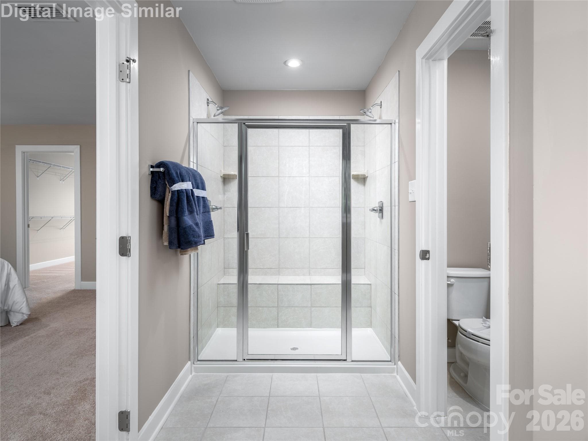 Optional Roman shower with built-in seat and dual shower heads — a spa-like experience right at home. - Charlotte