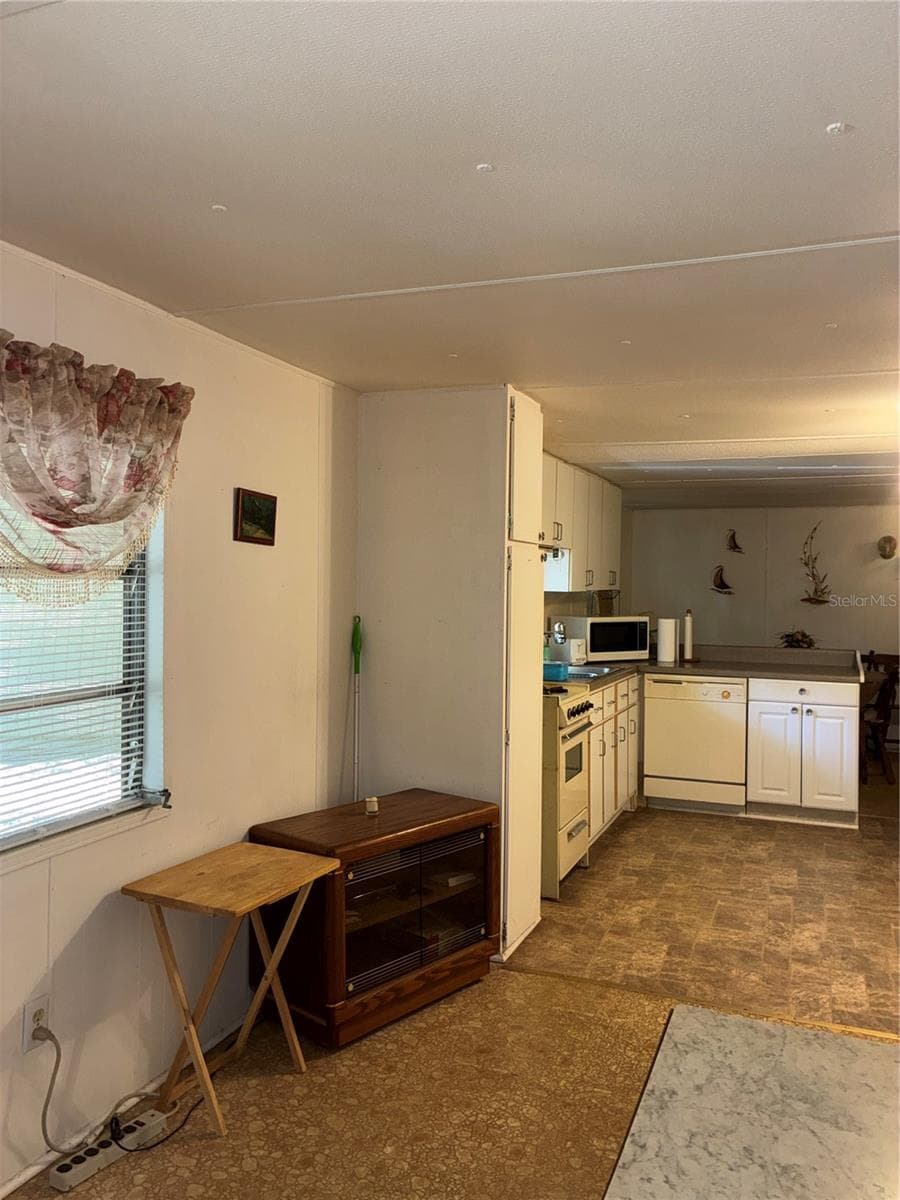 View of wall with window in the living room opposite the couch. - 24533 PINK PANTHER RD, PAISLEY