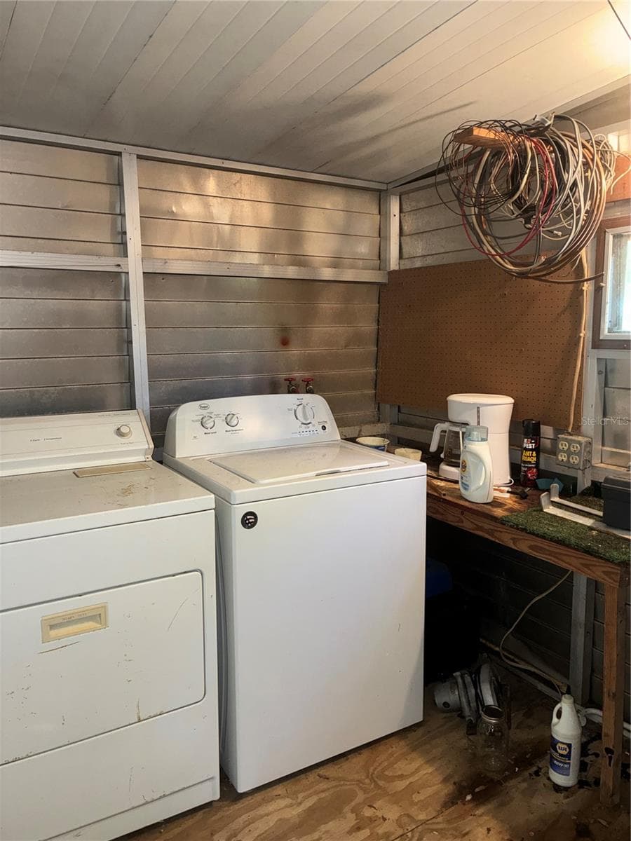 View of inside of rear storage shed showing washer and dryer and work bench. - 24533 PINK PANTHER RD, PAISLEY