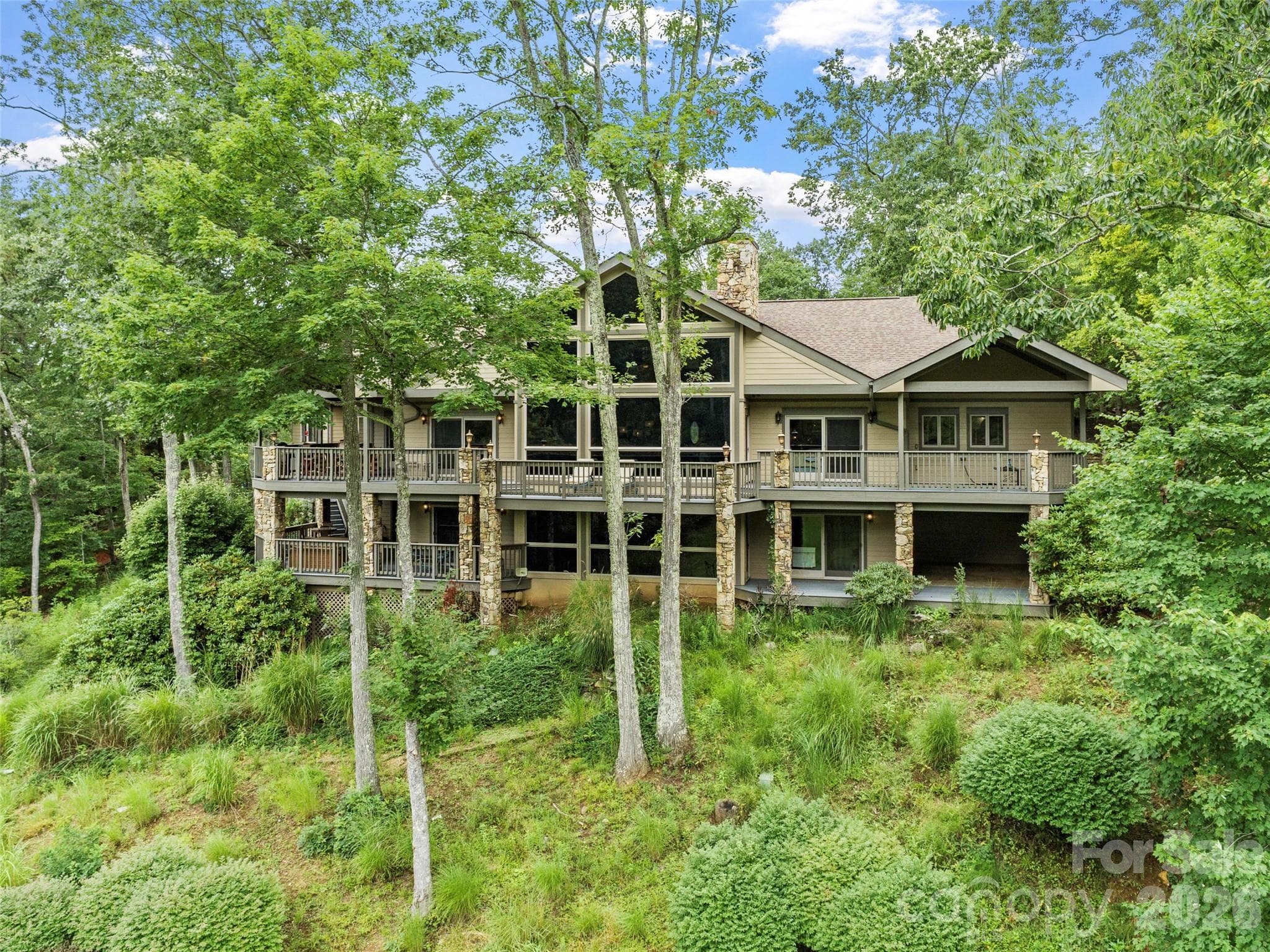 Stunning rear view of the home, nestled on the edge of the golf course - 151 Austin Mountain Drive, Burnsville