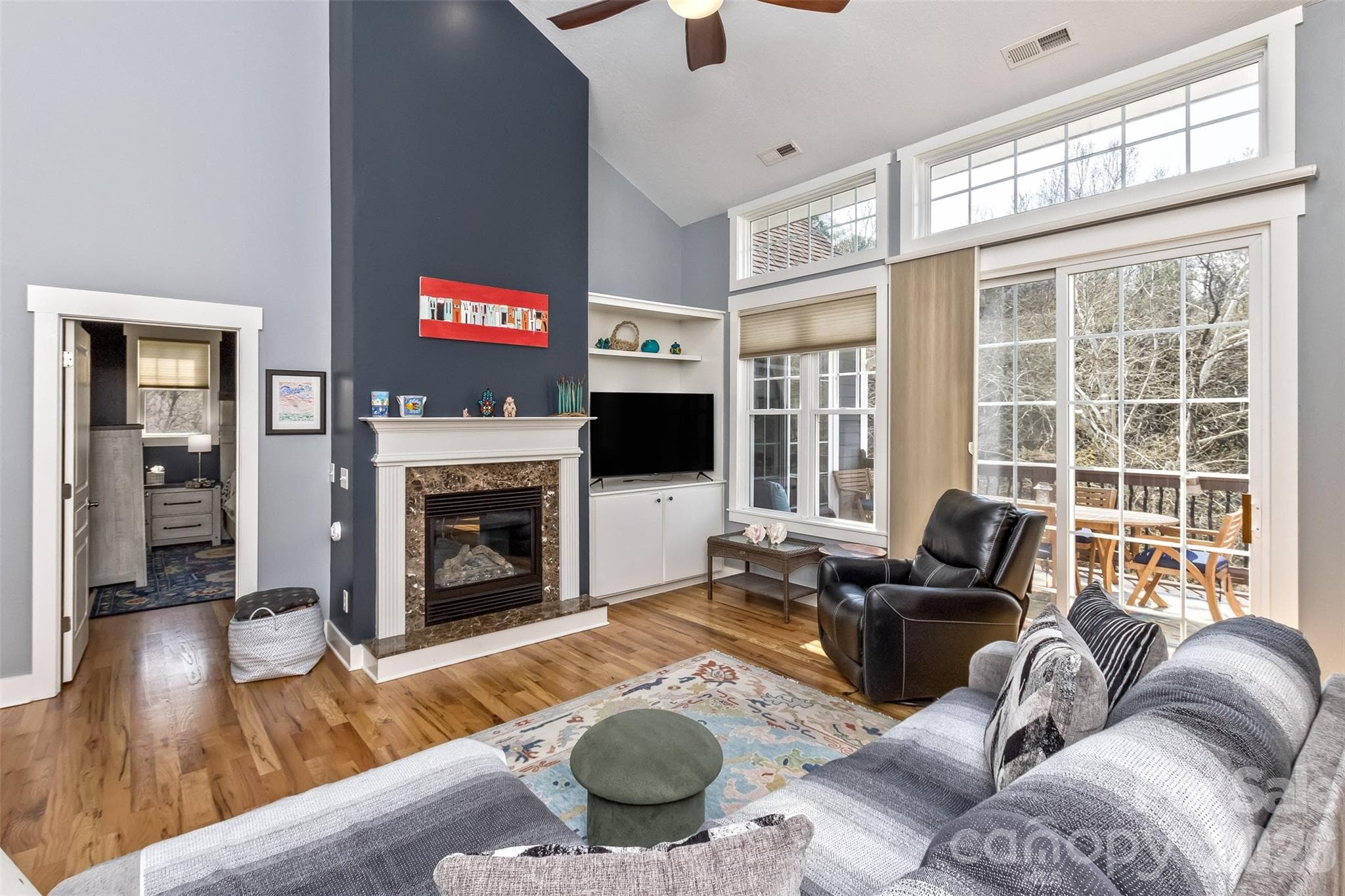 Another view of the light and bright living room with door out to the back deck - 37 Creekside View Drive, Asheville