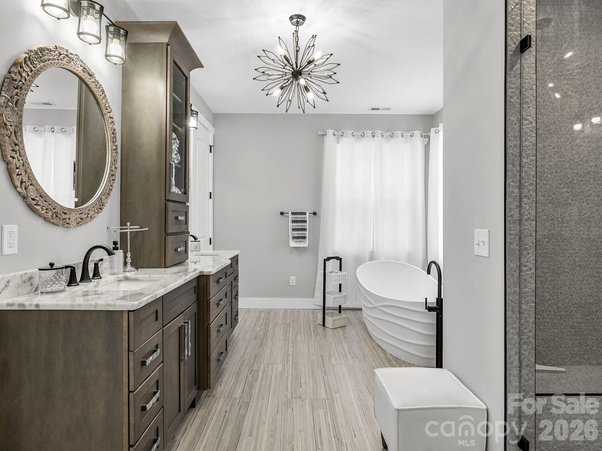 Primary bath suite featuring double vanity, deep soaking tub and shower. - 345 Preservation Trail, Columbus
