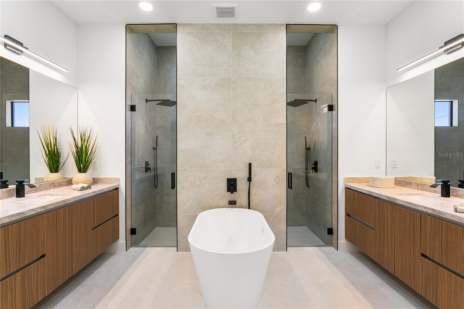 SPA-STYLE BATH featuring dual shower system, freestanding tub & marble vanities - 3300 NW 1ST TER, CAPE CORAL