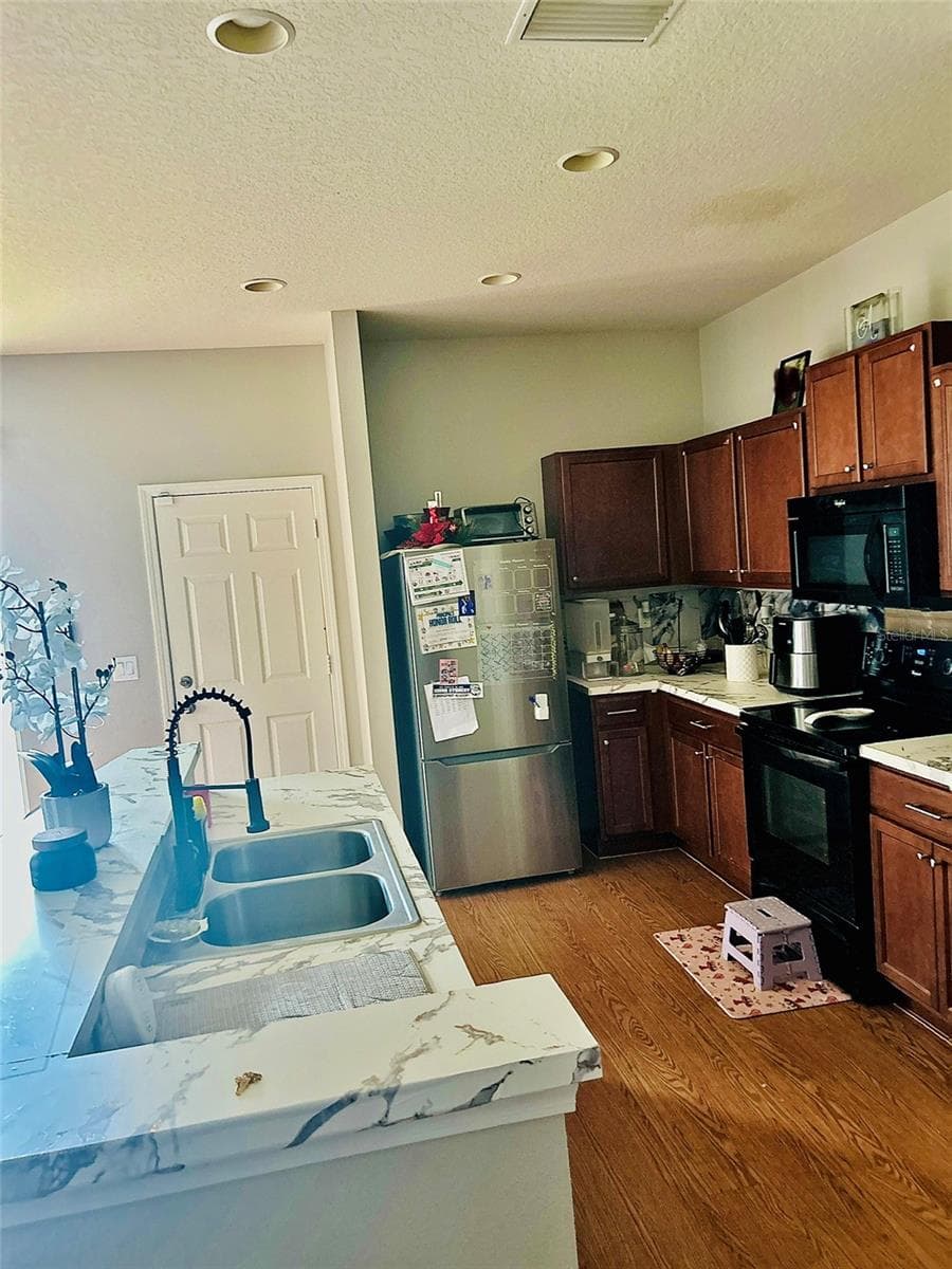 Kitchen (family photos blurred) - 4411 BANYAN TREE PL, RIVERVIEW