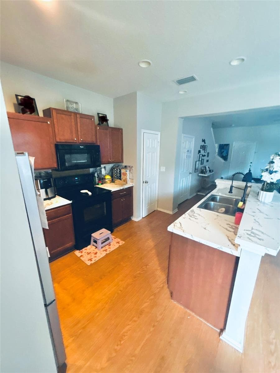 Kitchen (family photos blurred) - 4411 BANYAN TREE PL, RIVERVIEW