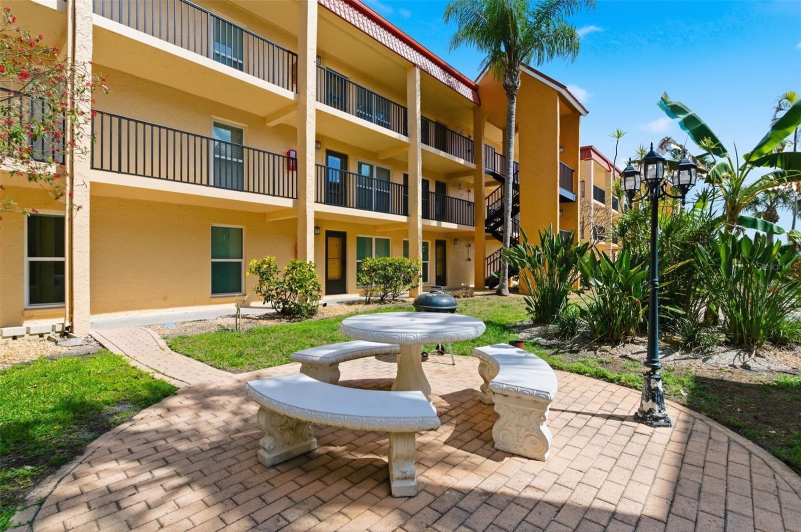 Barbeque grill in courtyard - many cookouts during the season - 8901 BLIND PASS RD #127, ST PETE BEACH