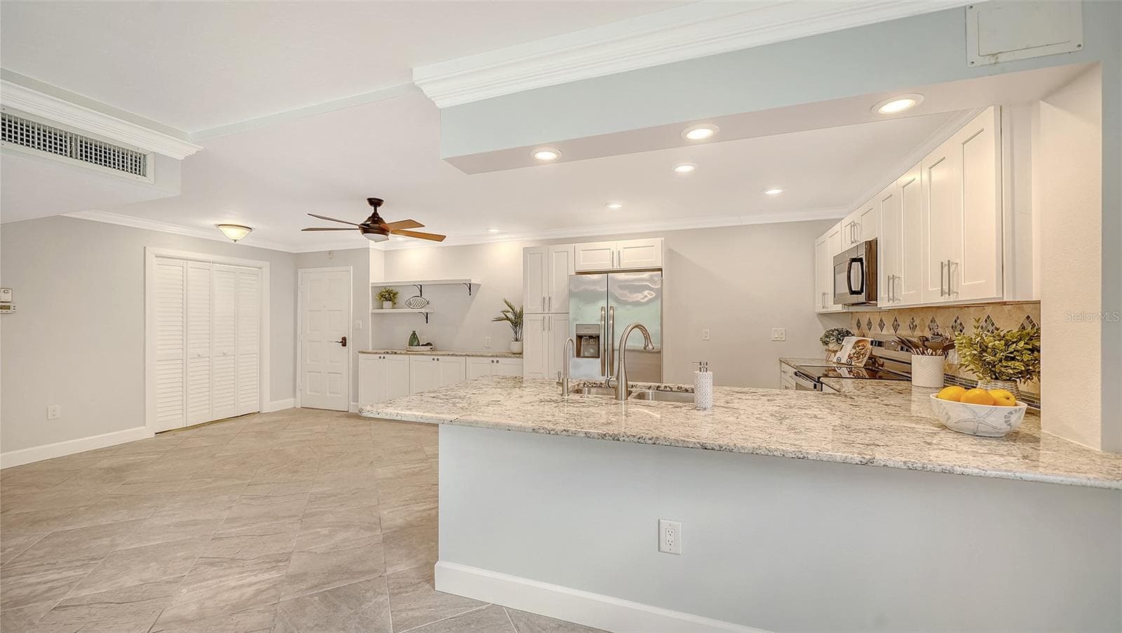 The newly remodeled kitchen features a 9' breakfast bar and granite countertops. - 225 HOURGLASS WAY #106, SARASOTA