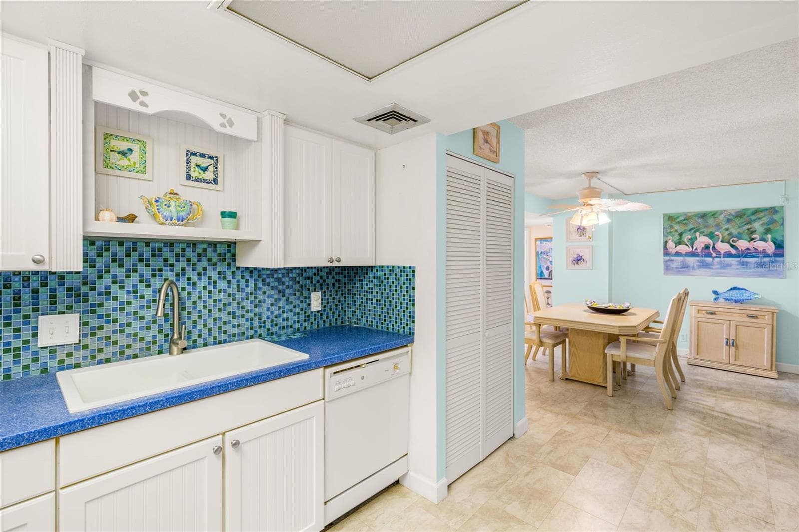 Flows from Kitchen to Dining Area - that louvered closet holds the Washer / Dryer - 1 KEY CAPRI #102E, TREASURE ISLAND