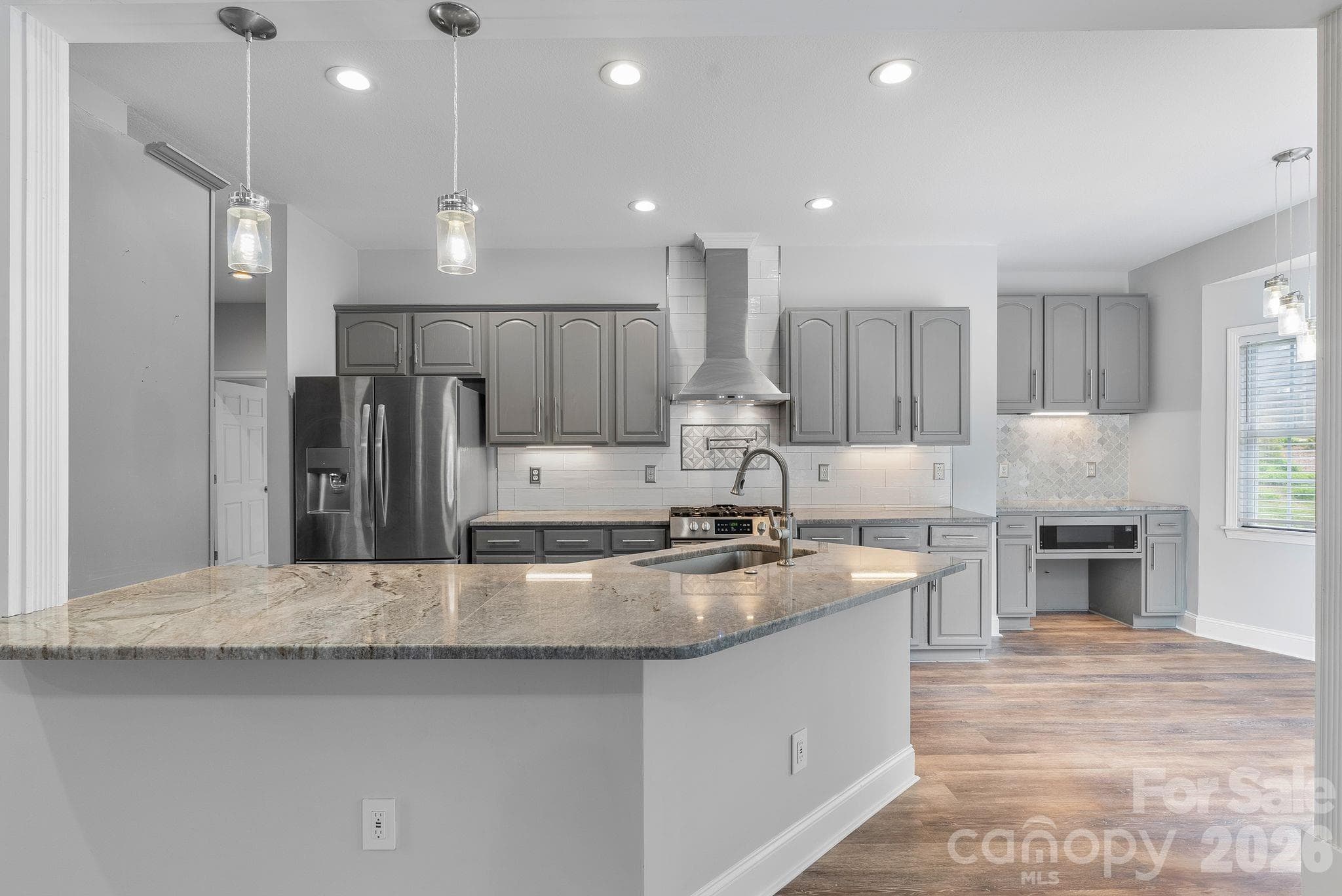 Open kitchen for ease and entertainment opens to the sunset with large cable decking for family, friends and entertainment. - Hendersonville