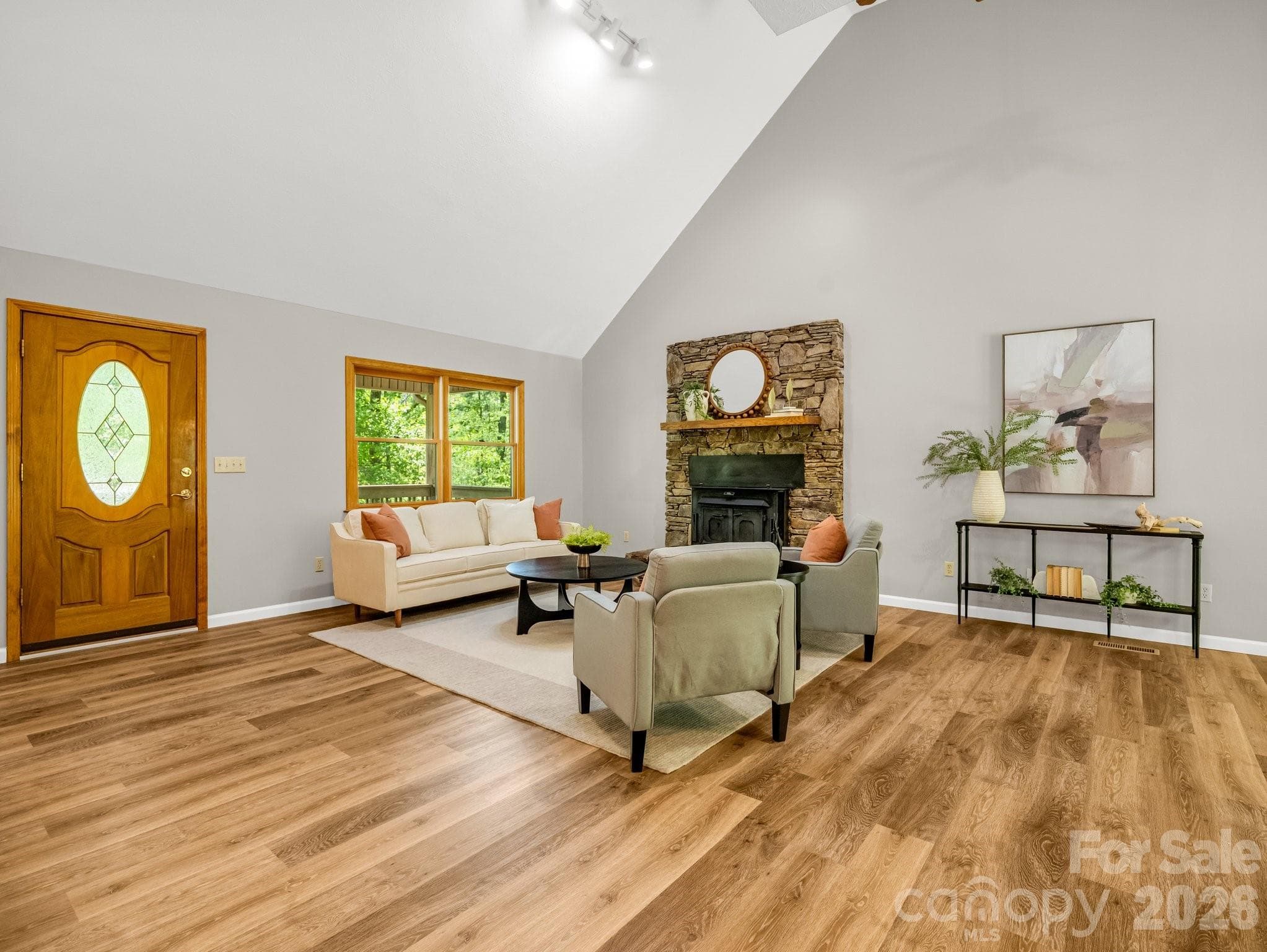 Vaulted ceilings and stone fireplace with wood burning stove - 2304 Mountain Page Road, Saluda
