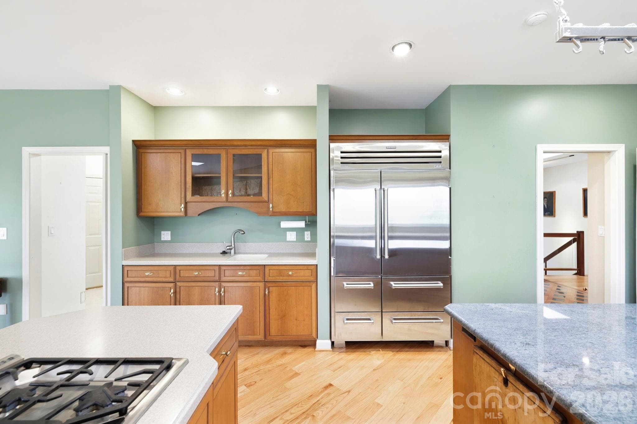 Appliances include a Sub-Zero refrigerator, Thermador gas cooktop, and wall oven - 100 Elmridge Drive, Flat Rock