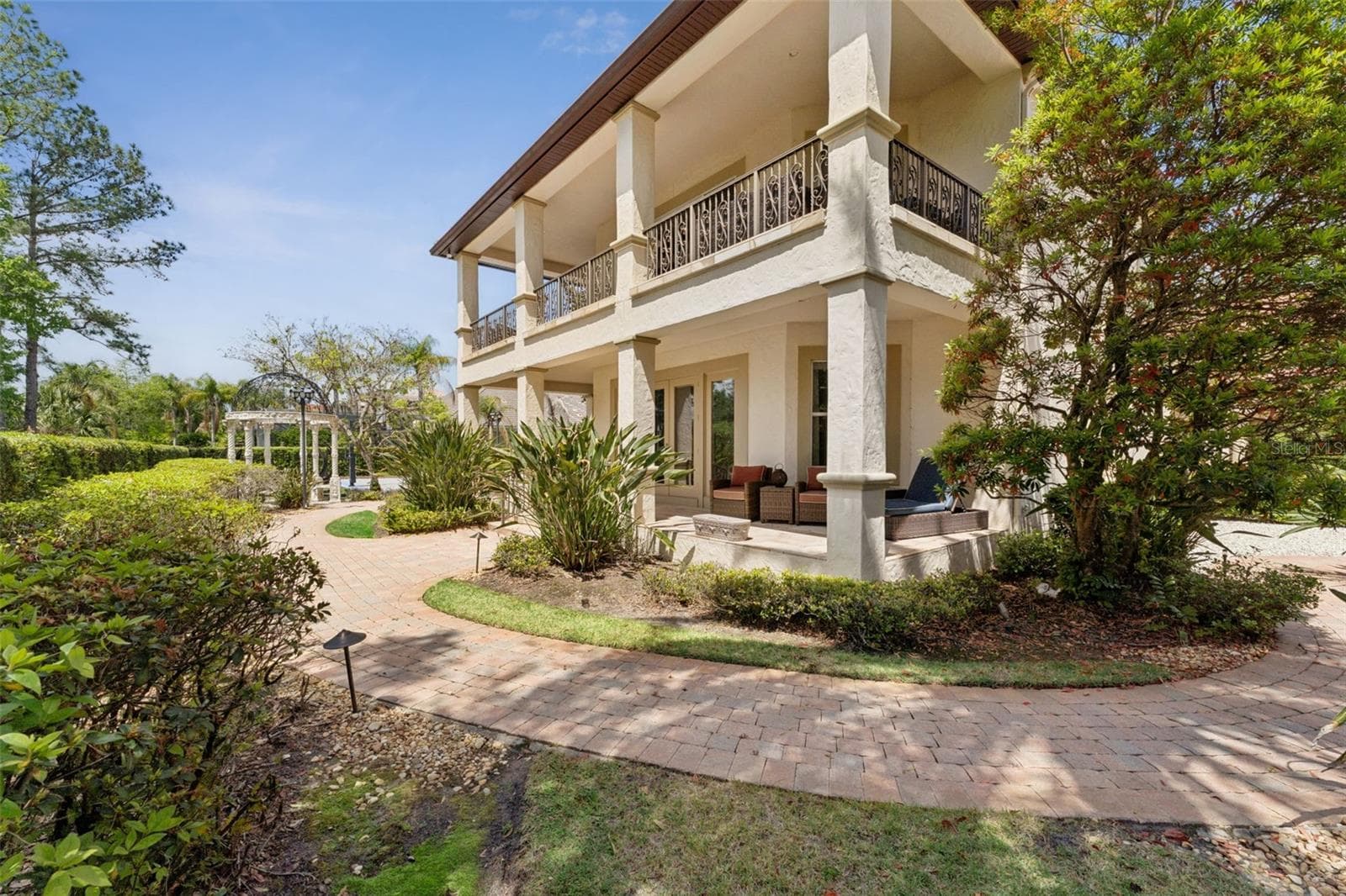 Backside of the guest house with a balcony and covered lanai space - 3545 LEGACY HILLS CT, LONGWOOD