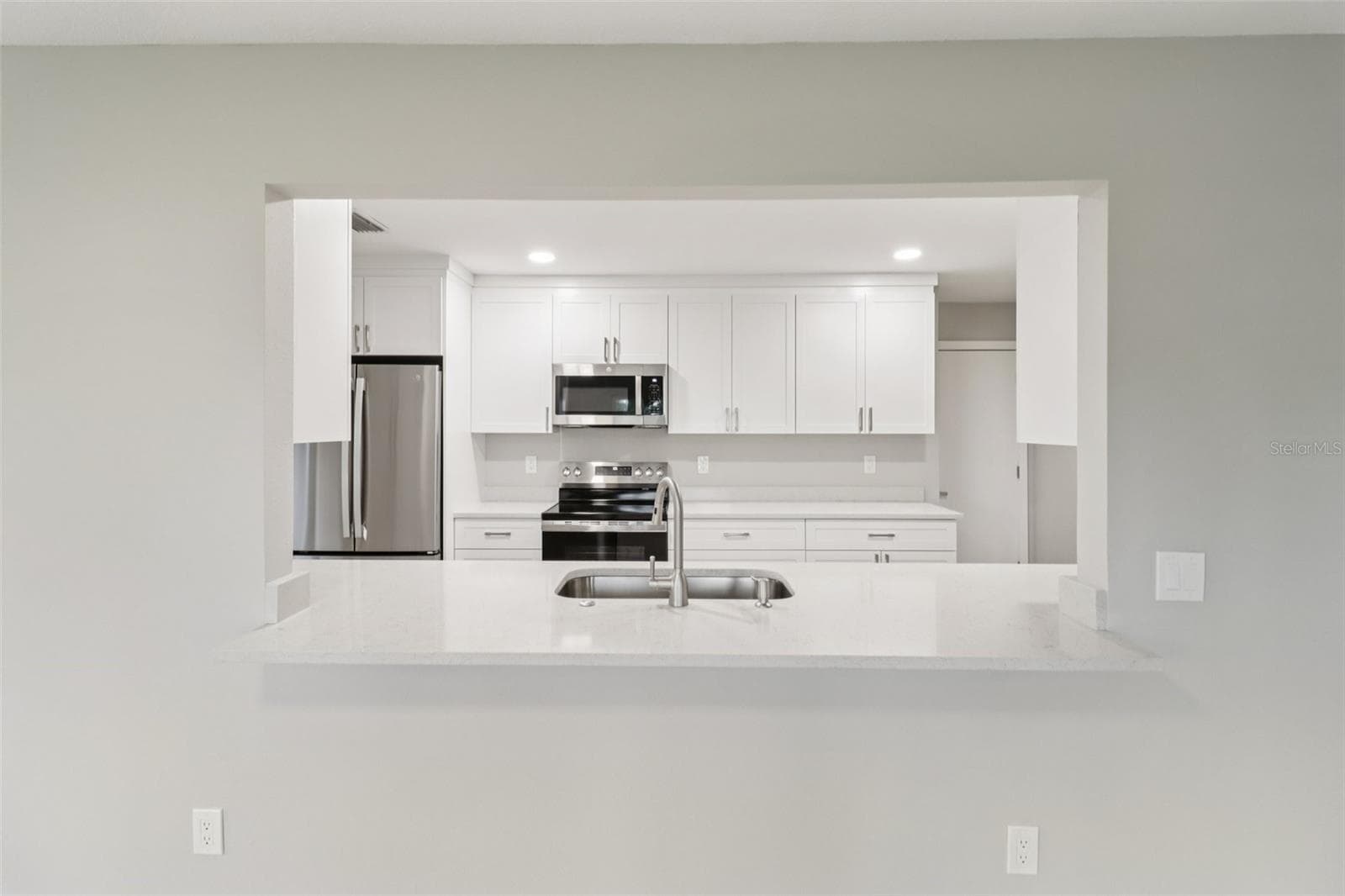 Breakfast bar passthrough keeps the home chef connected! - 1412 DIGARMO TER, DELTONA