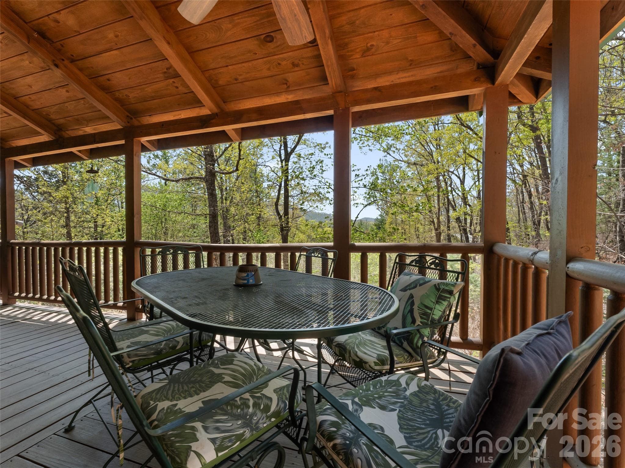 Enjoy meals on the porch with serene mountains as a backdrop. - 462 Deep Woods Lane, Saluda