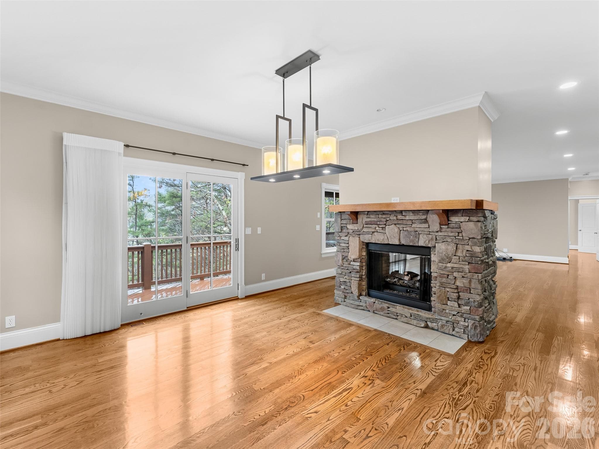 The dining room looks out onto the back deck and features a gas fireplace. - 5 Stegall Lane, Asheville