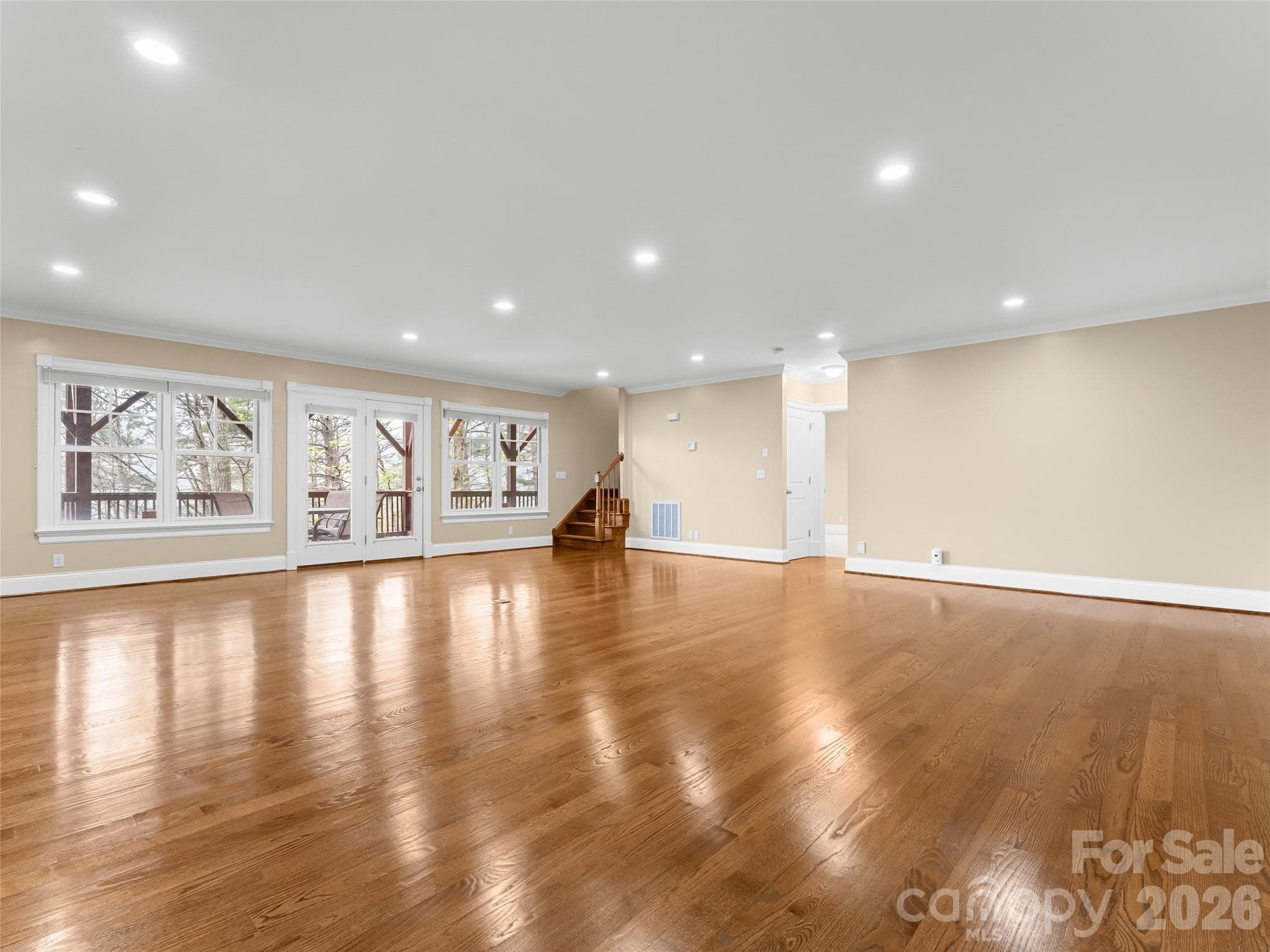 Plenty of light, despite being a basement. Doors lead out to the lower level deck. - 5 Stegall Lane, Asheville