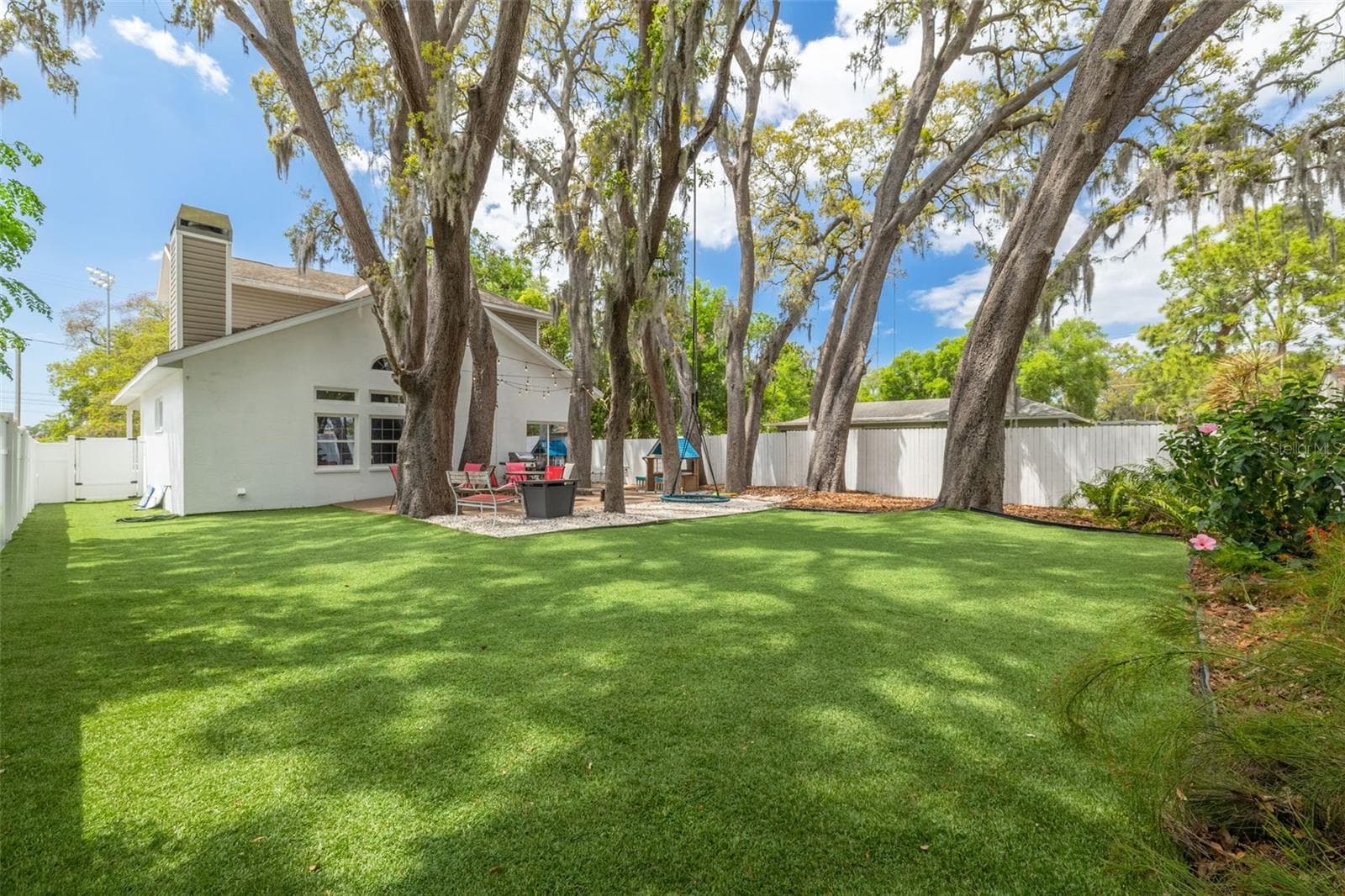 12 enormous live oak trees create a canopy over the oversized back yard, a beautiful setting for gathering all ages. - 901 VIRGINIA AVE, TARPON SPRINGS