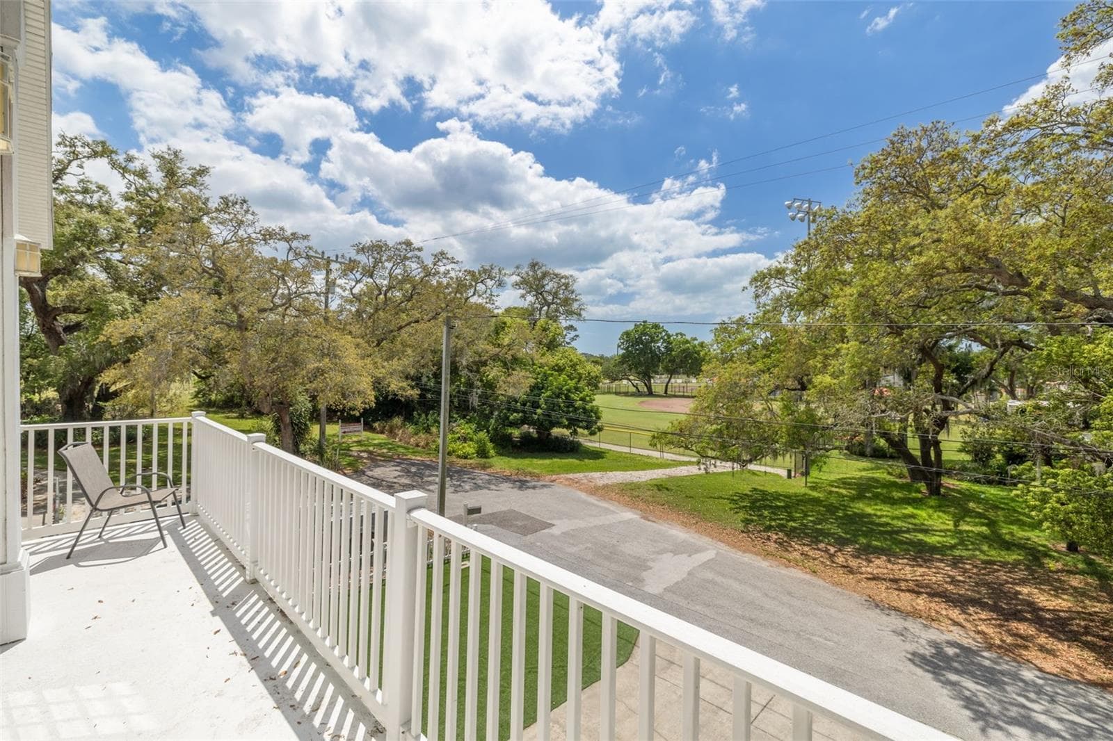 Watch little league baseball games relaxing on the master bedroom deck, hearing the crack of the bats and cheers from the crowds. - 901 VIRGINIA AVE, TARPON SPRINGS
