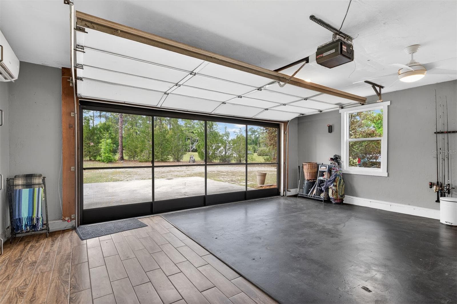 Garage space with insulated door up - 9406 SW 78TH CT, GAINESVILLE