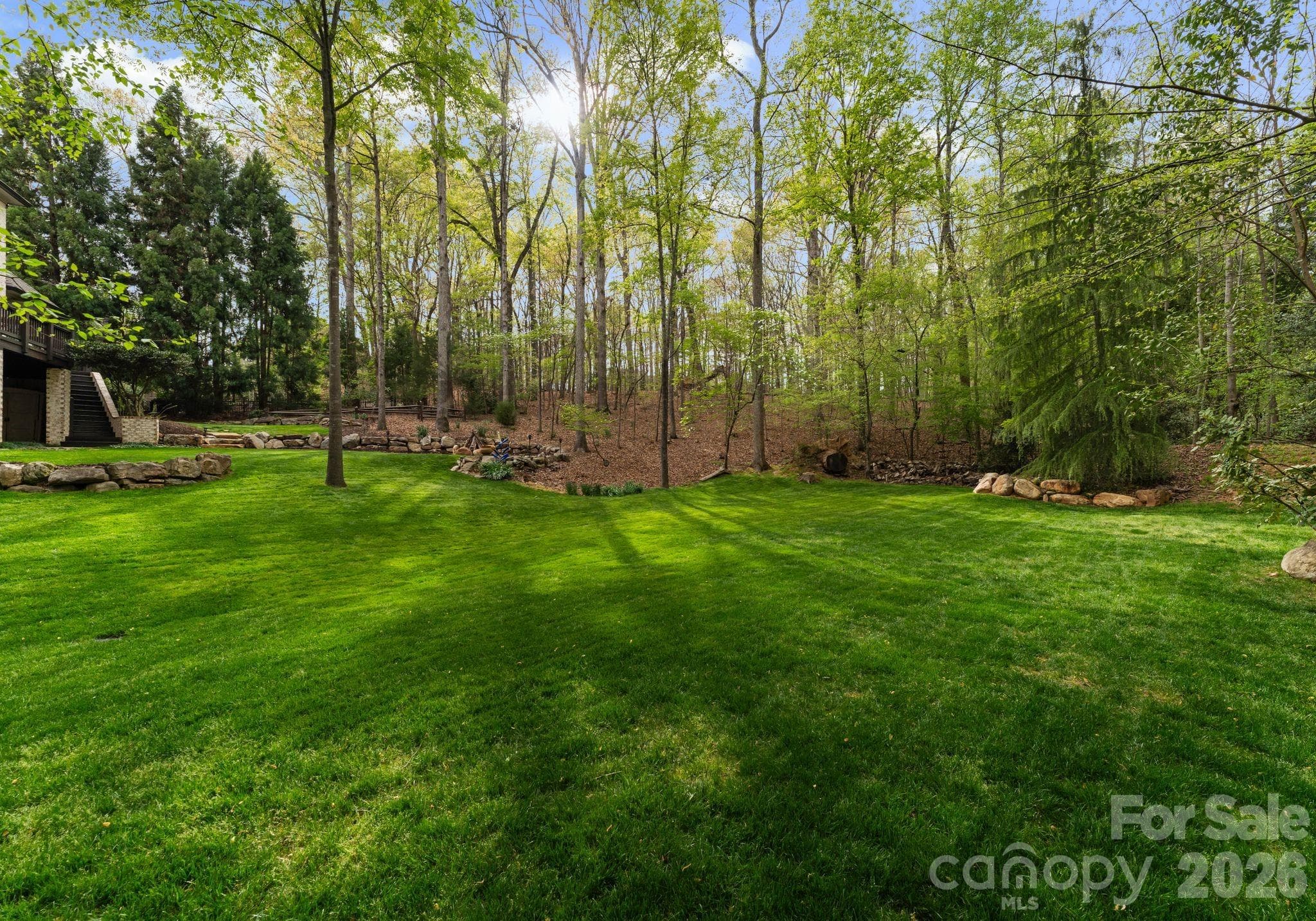 Expansive lower level of backyard surrounded by additional green space - 1514 Elmsford Lane, Matthews