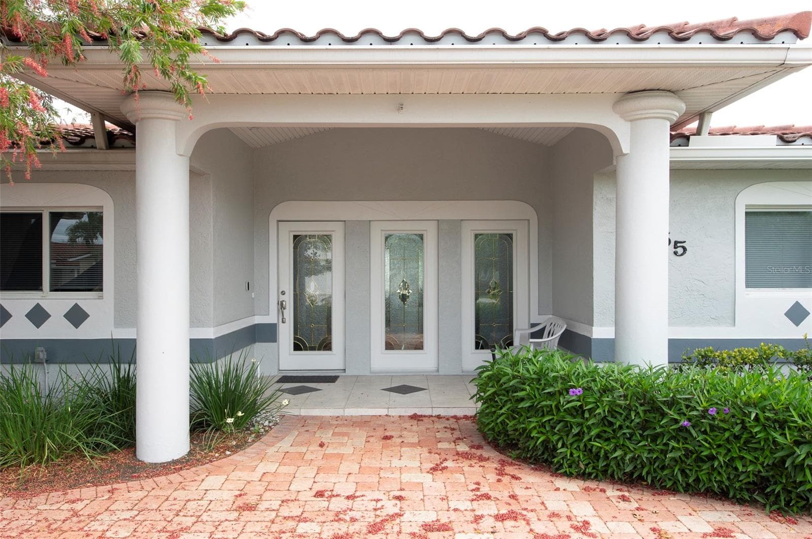 Entryway features stately white columns - 11855 4TH ST E, TREASURE ISLAND
