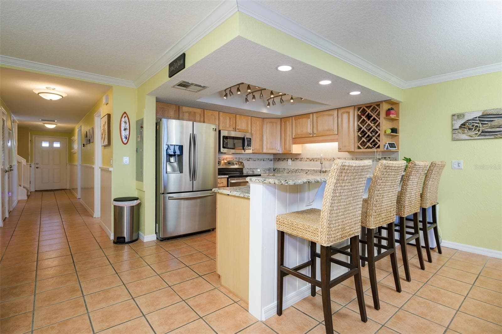 Walk through the front door from the West, past the primary bedroom, half bath and into the kitchen - 4421 S ATLANTIC AVE #A2, PONCE INLET