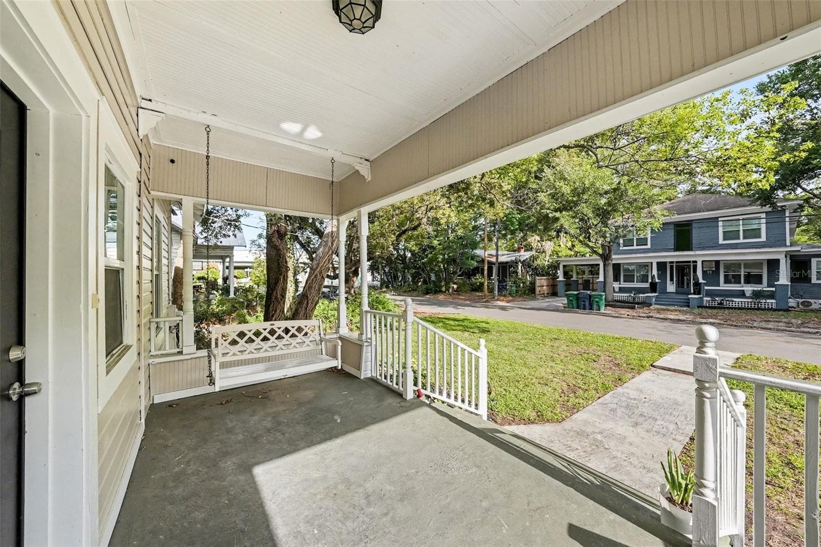 Welcoming front porch, perfect for morning coffee or evening relaxation. - 805 E CHELSEA ST, TAMPA